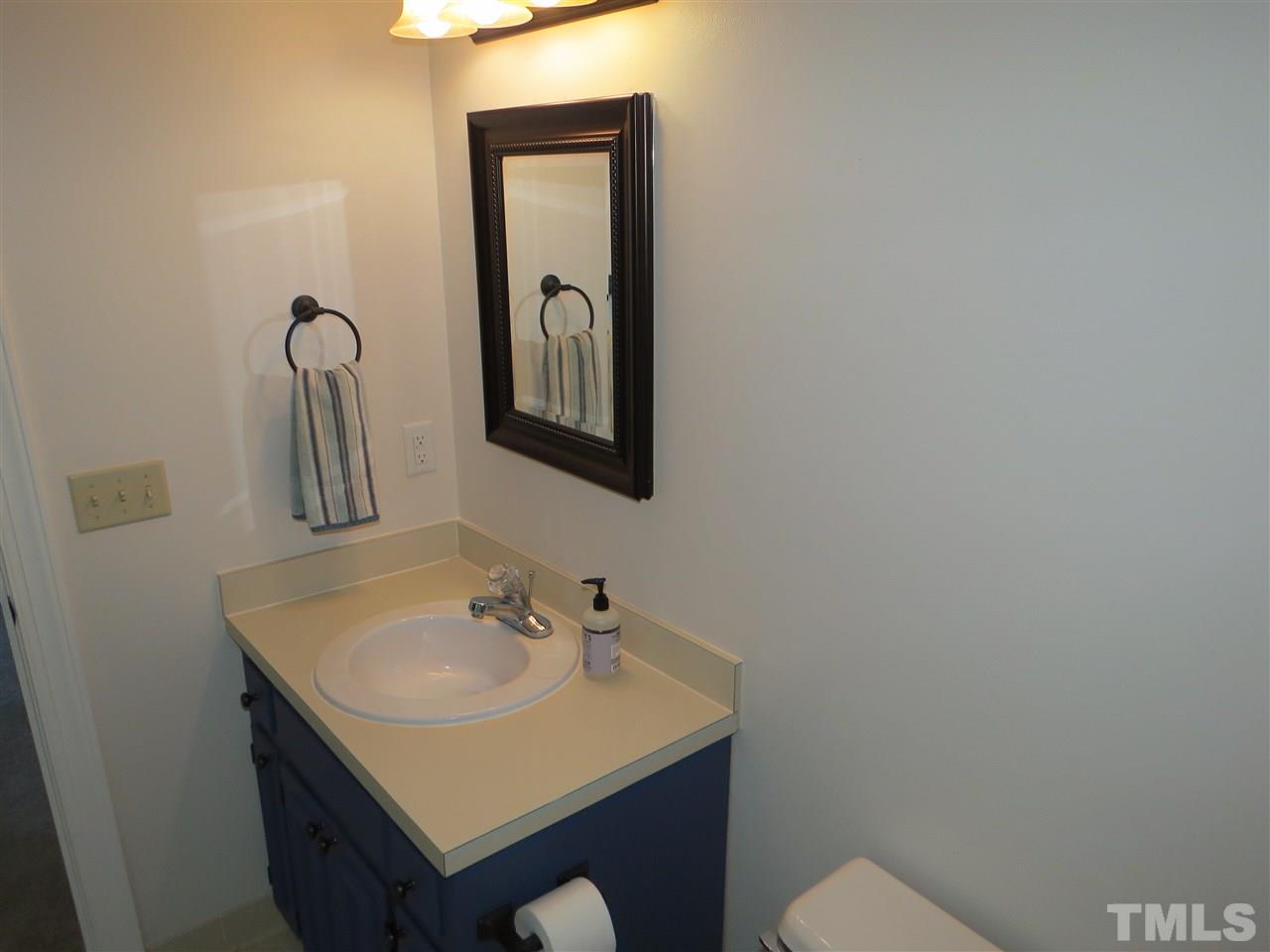 905 Skinners Ridge Road Raleigh, NC 27614 - Photo 14 of 21 a bathroom with a sink vanity and mirror
