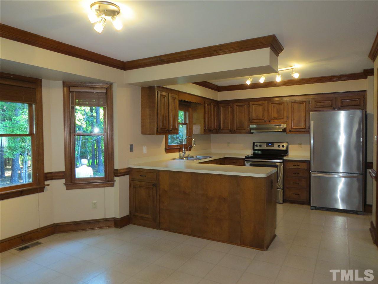 905 Skinners Ridge Road Raleigh, NC 27614 - Photo 4 of 21 a kitchen with stainless steel appliances granite countertop a refrigerator a sink dishwasher a stove and a refrigerator with wooden floor