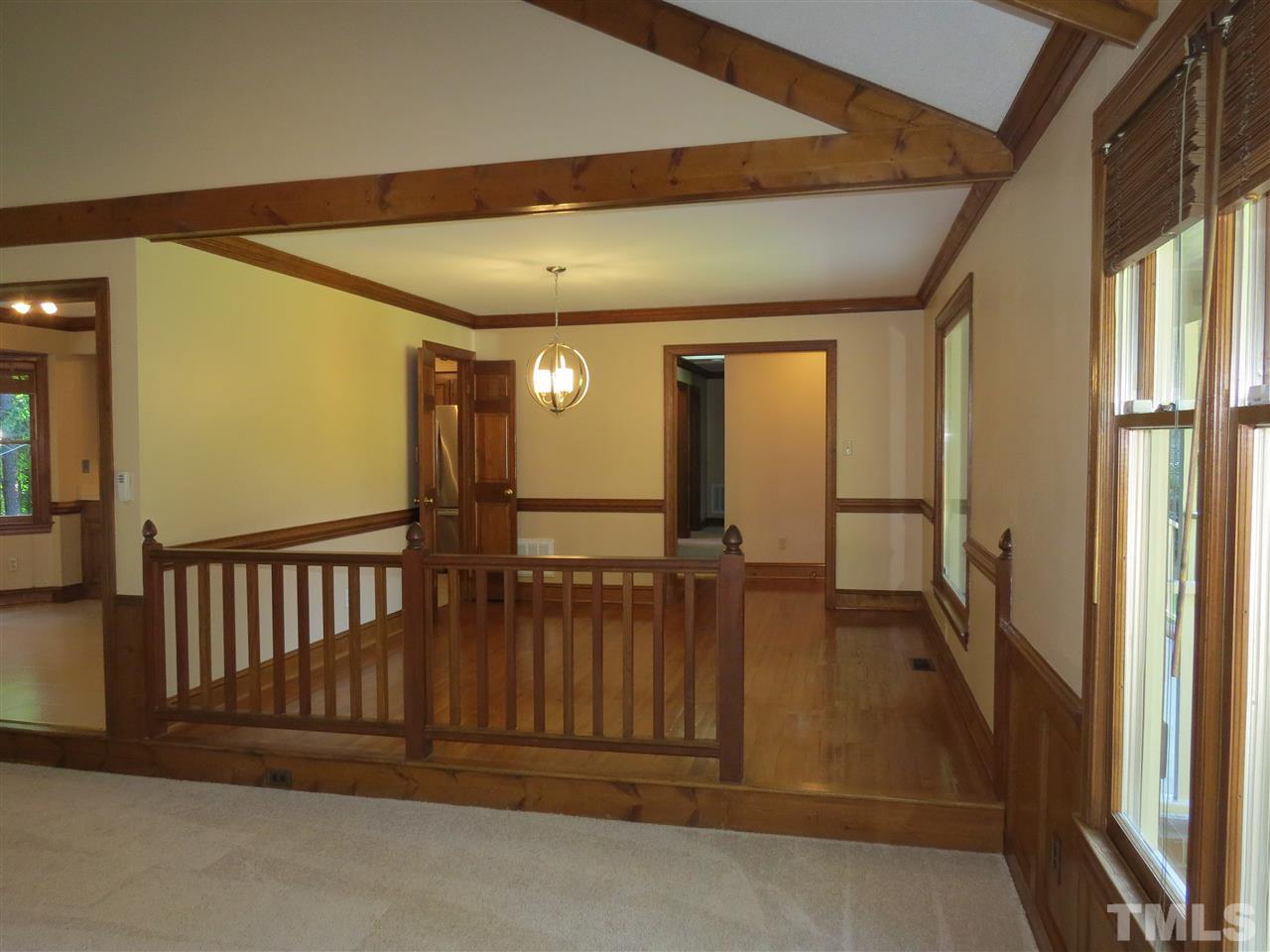905 Skinners Ridge Road Raleigh, NC 27614 - Photo 8 of 21 a view of a hallway with wooden floor and windows
