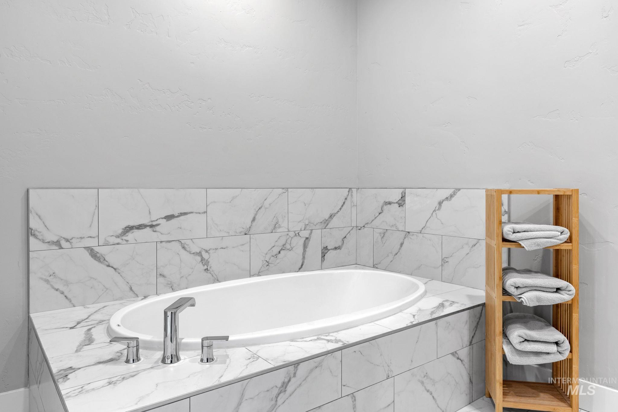 2934 East Murchison Street Meridian, ID 83642 - Photo 25 of 44 Built-in soaking tub with marble-look tile surround and chrome fixtures