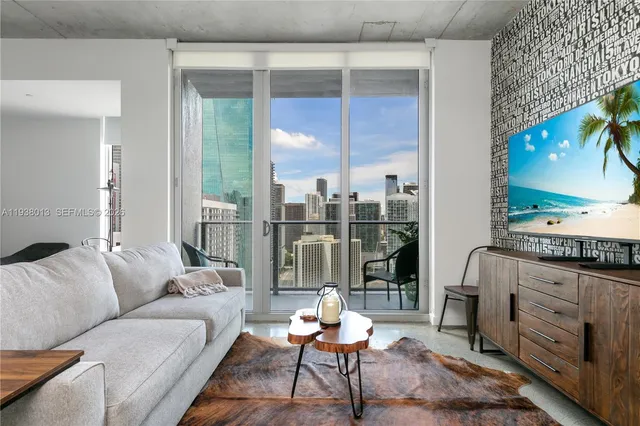 a living room with furniture and a floor to ceiling window
