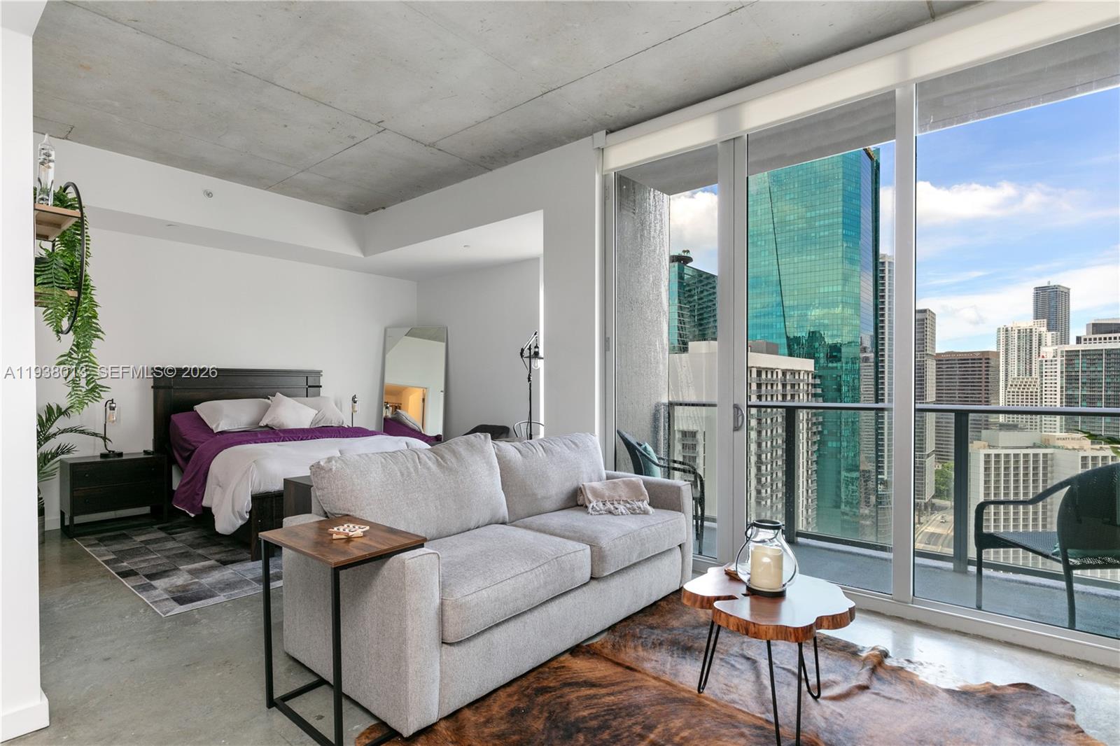 151 Southeast 1st Street, Unit 3103 Miami, FL 33131 - Photo 16 of 51 a bedroom with furniture and a large window