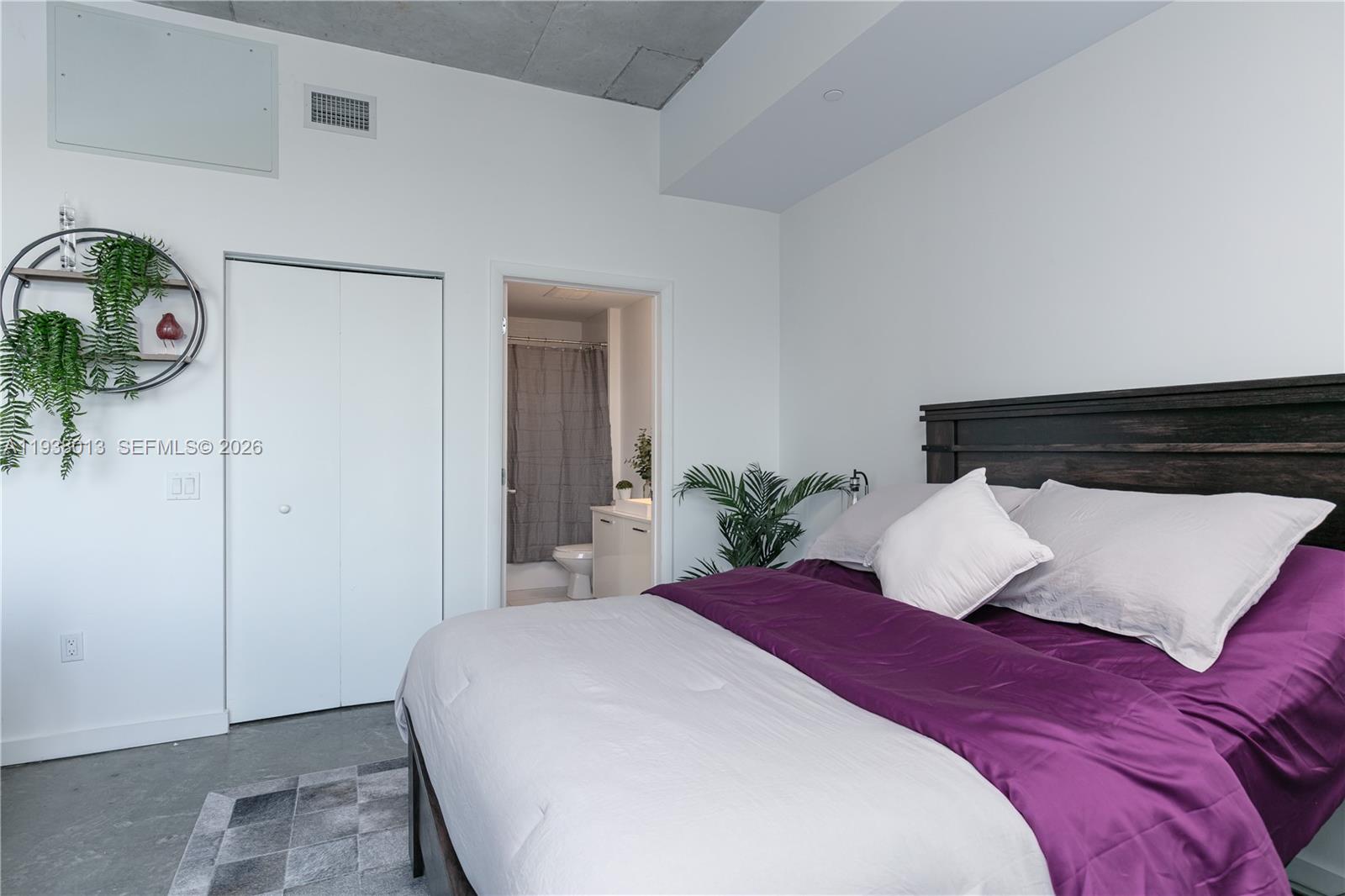 151 Southeast 1st Street, Unit 3103 Miami, FL 33131 - Photo 19 of 51 a bedroom with a bed and a potted plant
