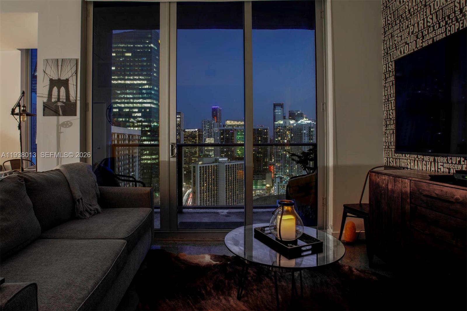 151 Southeast 1st Street, Unit 3103 Miami, FL 33131 - Photo 2 of 51 a living room with furniture a lamp and a fireplace