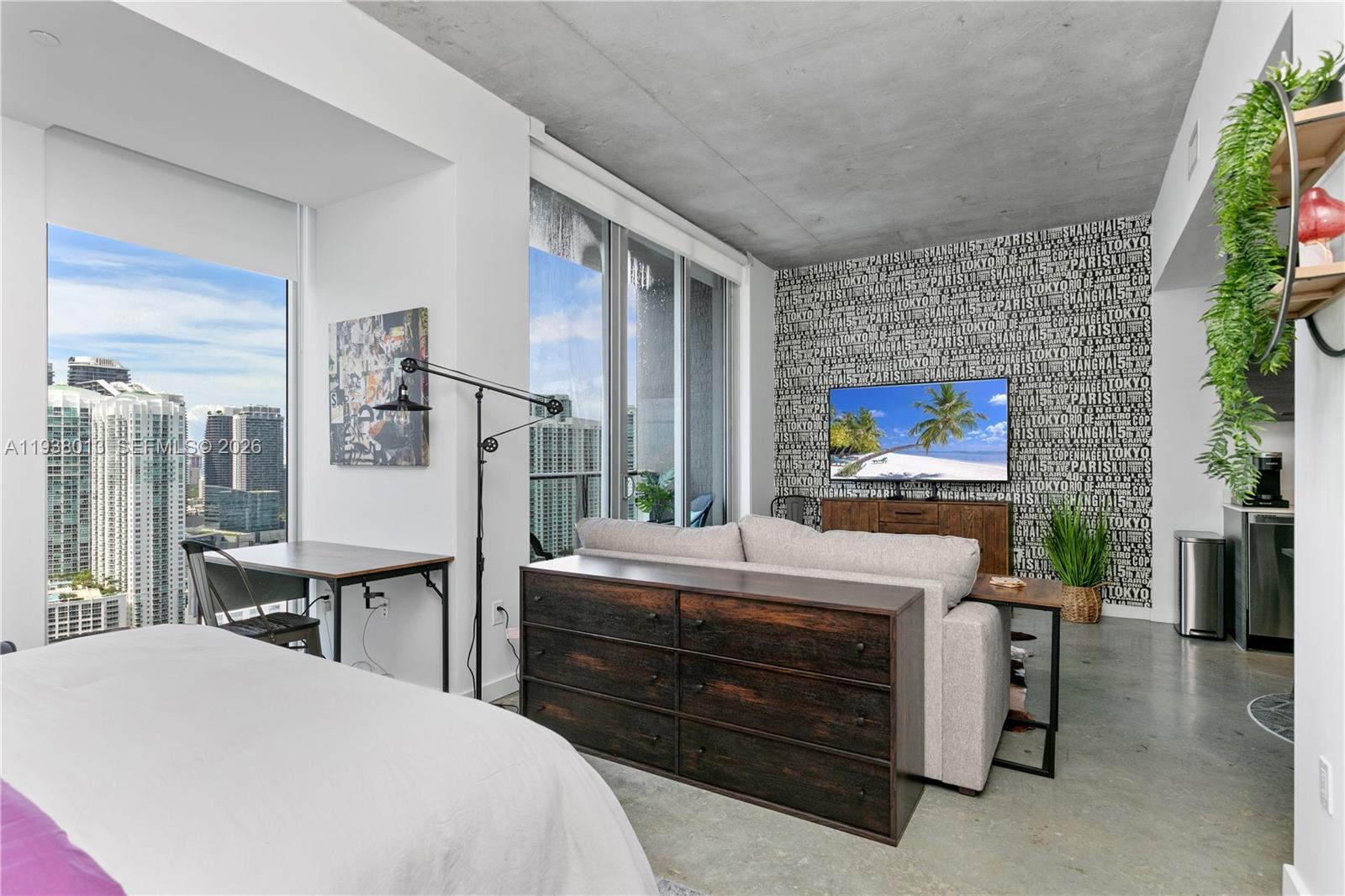 151 Southeast 1st Street, Unit 3103 Miami, FL 33131 - Photo 22 of 51 a bedroom with a bed and a flat screen tv