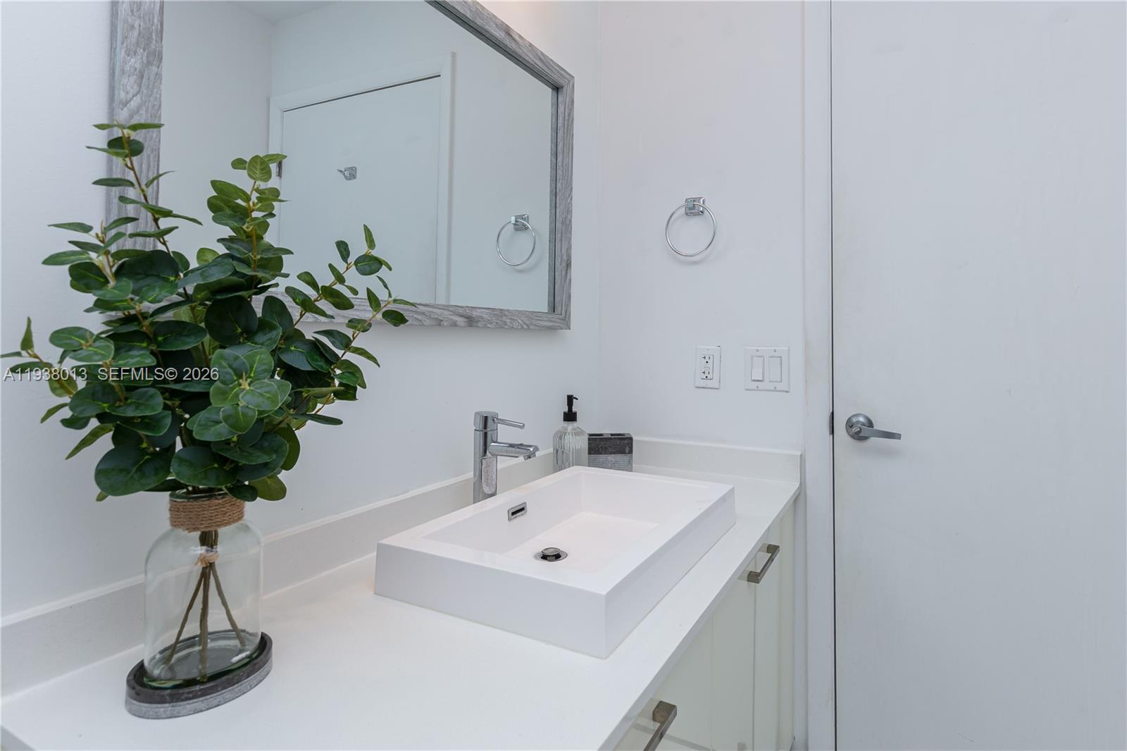 151 Southeast 1st Street, Unit 3103 Miami, FL 33131 - Photo 26 of 51 a bathroom with a sink a toilet and a mirror