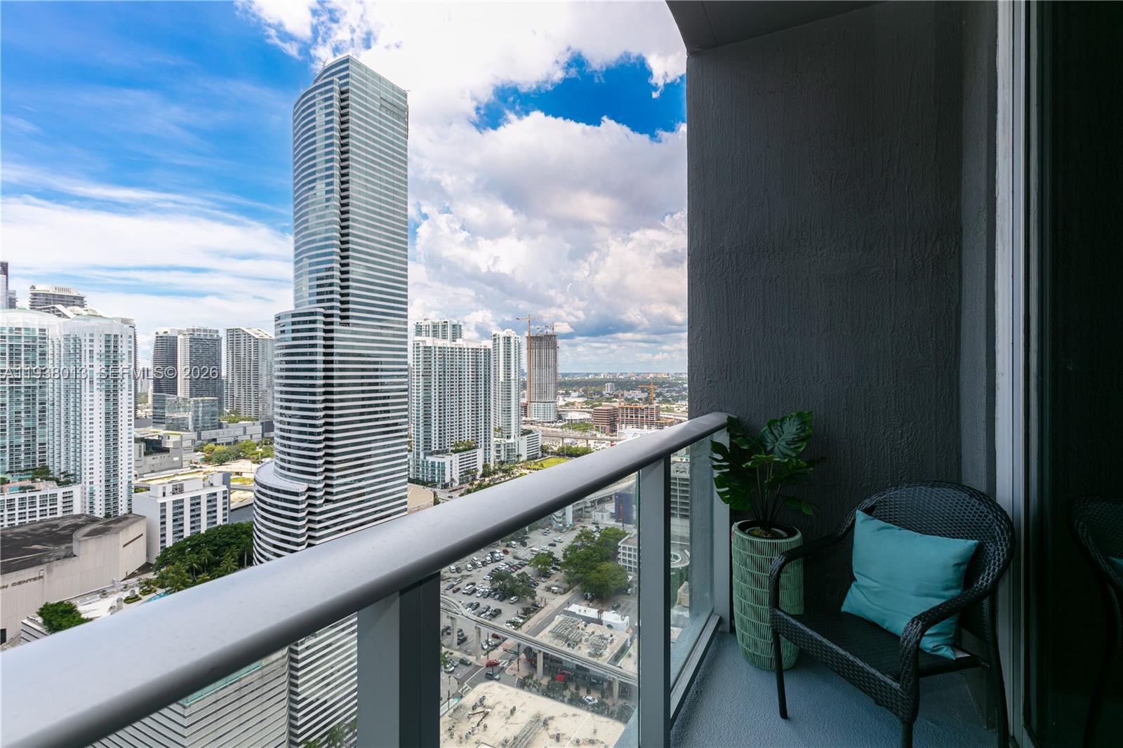 151 Southeast 1st Street, Unit 3103 Miami, FL 33131 - Photo 33 of 51 a view of a chair and table in balcony
