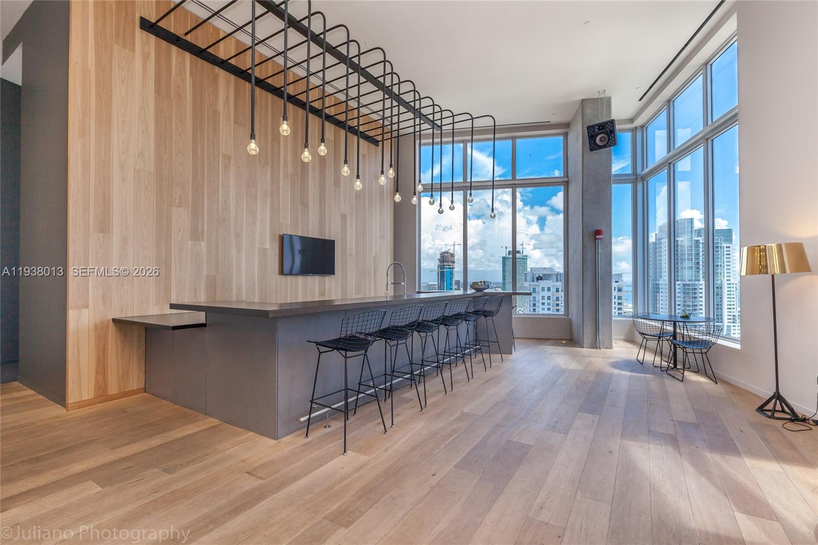 151 Southeast 1st Street, Unit 3103 Miami, FL 33131 - Photo 42 of 51 a room with lots of wooden furniture and windows