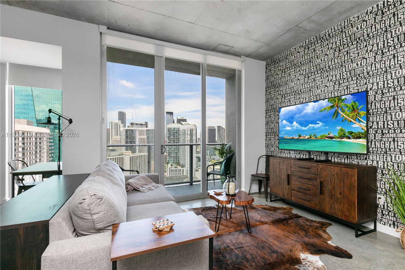 151 Southeast 1st Street, Unit 3103 Miami, FL 33131 - Photo 6 of 51 a living room with furniture a rug and a flat screen tv