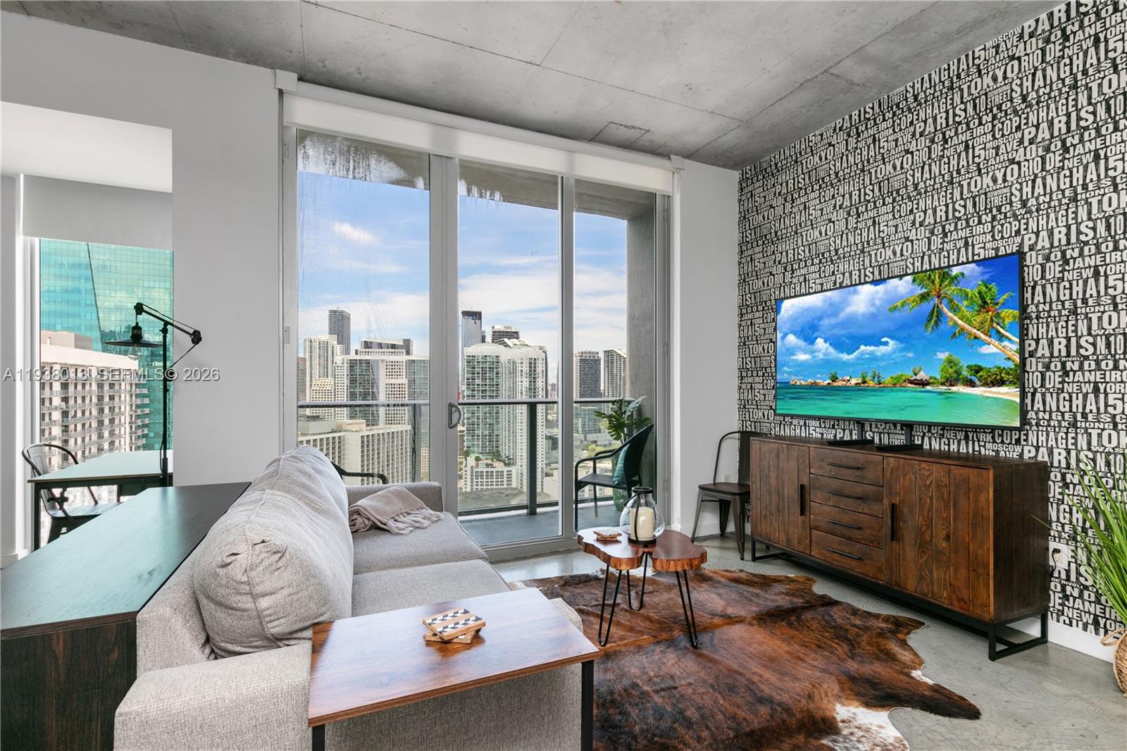 151 Southeast 1st Street, Unit 3103 Miami, FL 33131 - Photo 7 of 51 a living room with furniture a rug and a flat screen tv