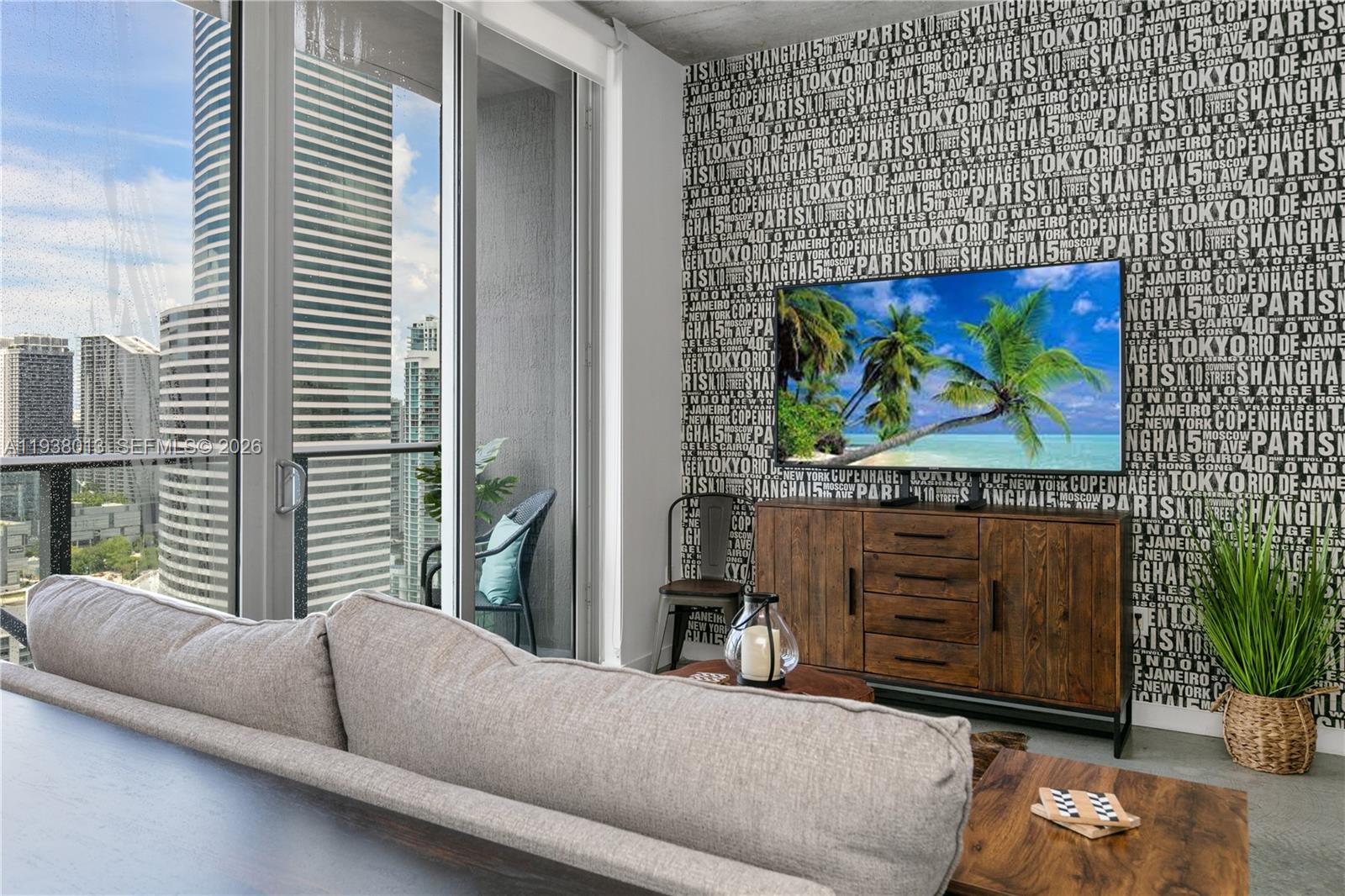 151 Southeast 1st Street, Unit 3103 Miami, FL 33131 - Photo 8 of 51 a living room with furniture and a flat screen tv