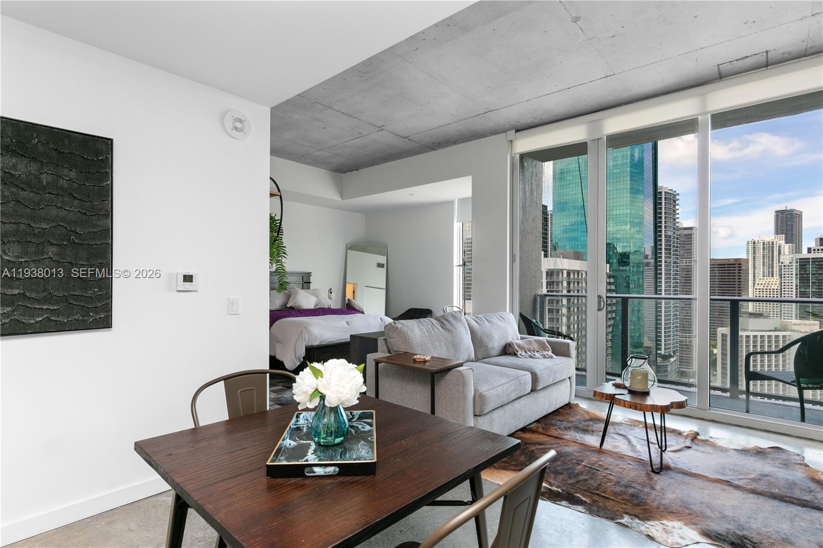 151 Southeast 1st Street, Unit 3103 Miami, FL 33131 - Photo 10 of 51 a living room with furniture wooden floor and a table