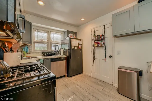 a kitchen with stainless steel appliances a stove a sink and a microwave