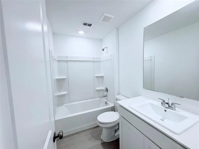 a bathroom with a double vanity sink toilet mirror and shower