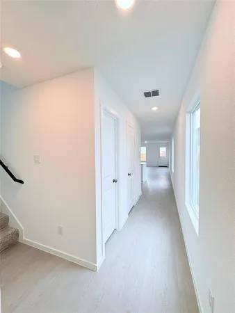 a view of a big room with closet and windows