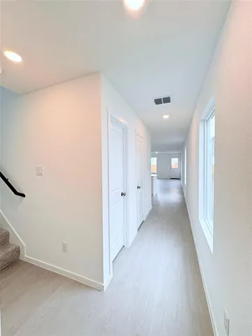 a view of a big room with closet and windows