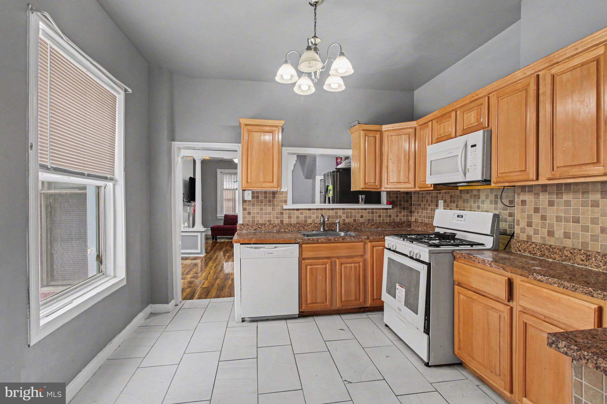 14 South Ruby Street Philadelphia, PA 19139 - Photo 11 of 28 a kitchen with stainless steel appliances granite countertop a stove sink and cabinets