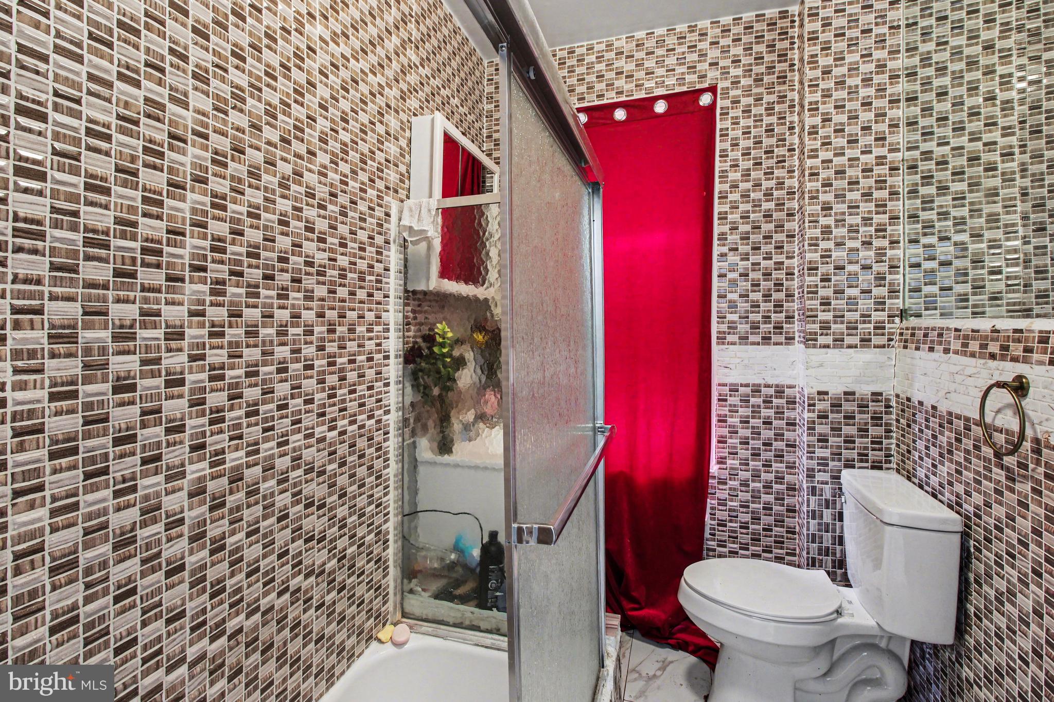 14 South Ruby Street Philadelphia, PA 19139 - Photo 18 of 28 a bathroom with a toilet and a shower curtain