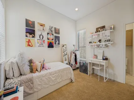 a bedroom with a bed and a desk