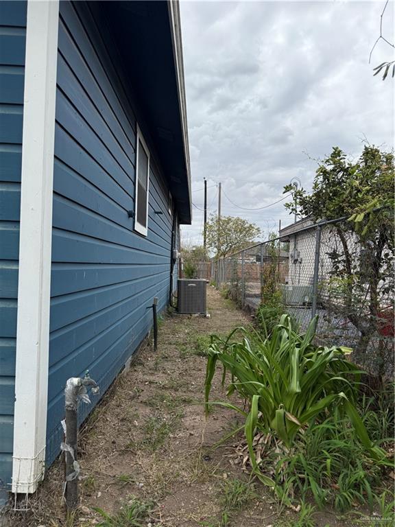 307 Hawaii Street Alton, TX 78573 - Photo 16 of 17 The property features blue siding and white trim, with a visible window on the side
