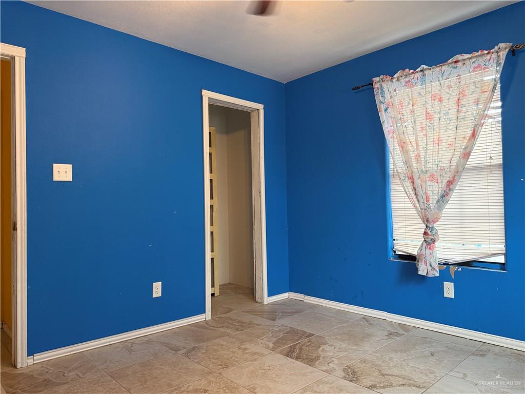 307 Hawaii Street Alton, TX 78573 - Photo 7 of 17 This room features tiled flooring and bright blue walls