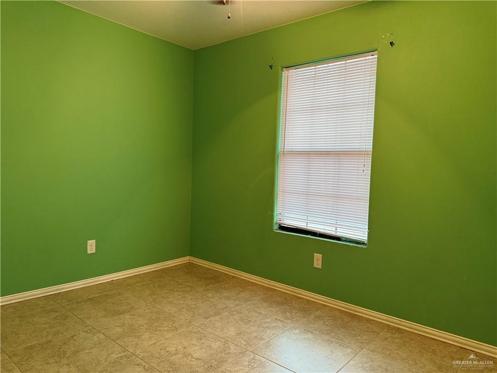 307 Hawaii Street Alton, TX 78573 - Photo 9 of 17 Room featuring green walls, a window with blinds, and tiled flooring