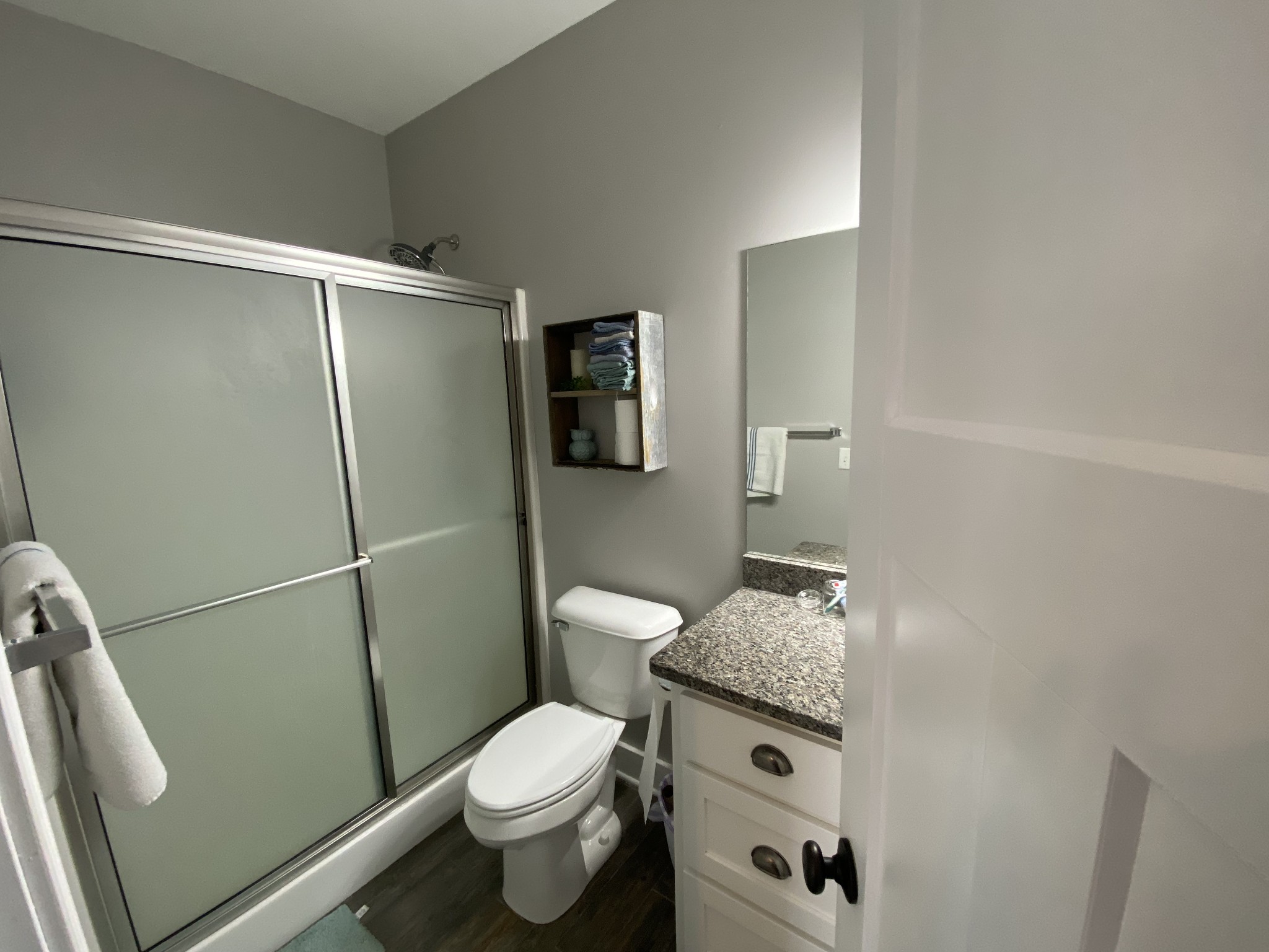 445 Moore Link Road Portland, TN 37148 - Photo 25 of 30 a bathroom with a granite countertop toilet a sink a shower and vanity