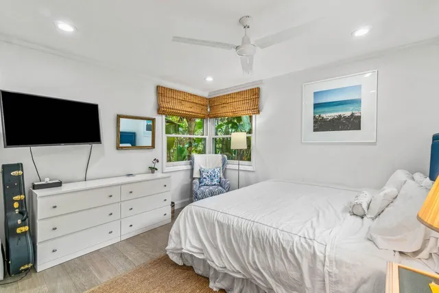 a bedroom with a large bed and a flat screen tv