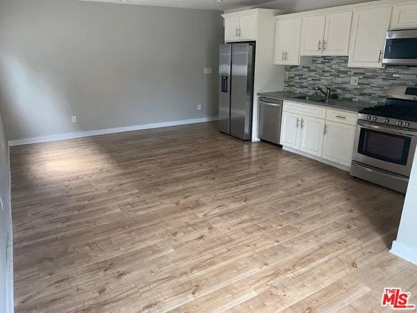 a kitchen with stainless steel appliances granite countertop a refrigerator sink and cabinets