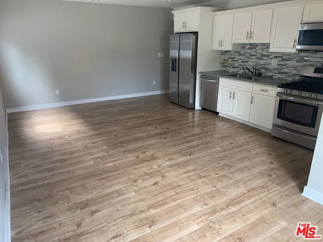 a kitchen with stainless steel appliances granite countertop a refrigerator sink and cabinets
