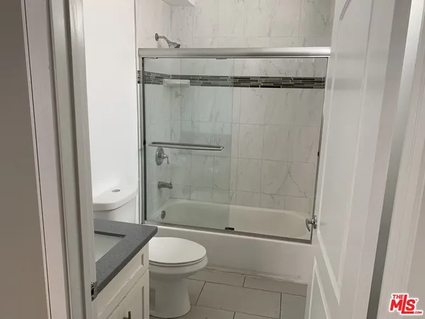 a bathroom with a shower and a toilet