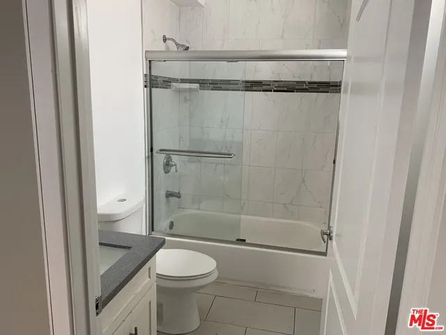 a bathroom with a shower and a toilet