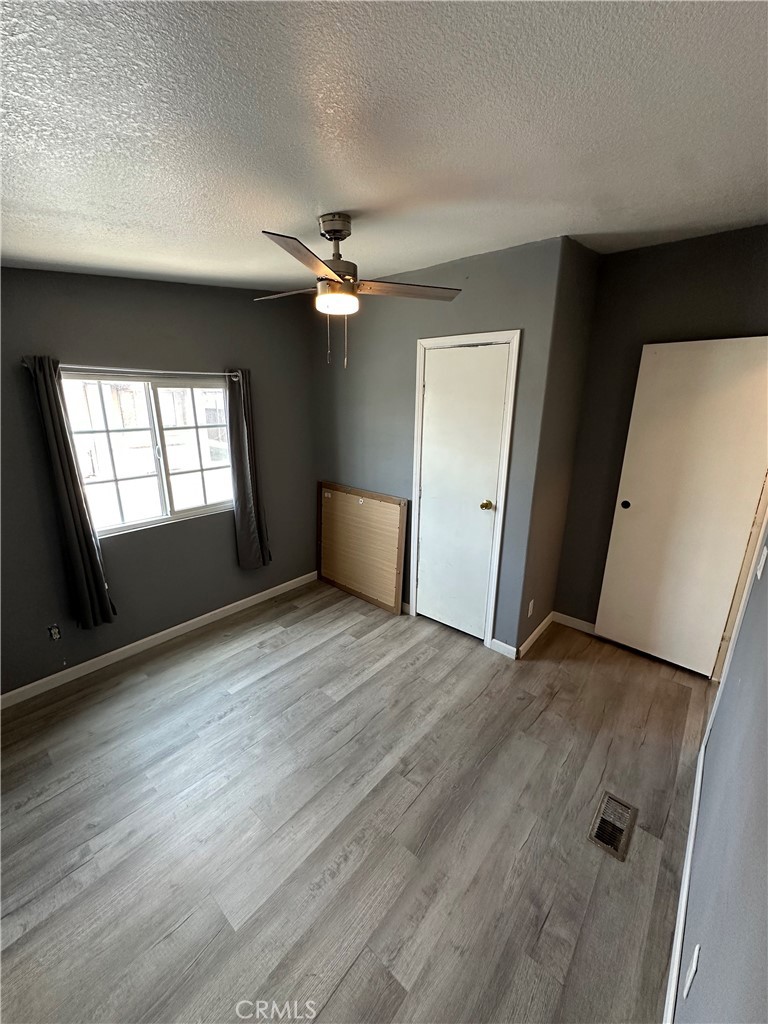 3825 Crestmore Road, Unit 414 Riverside, CA 92509 - Photo 18 of 31 wooden floor in an empty room with a window