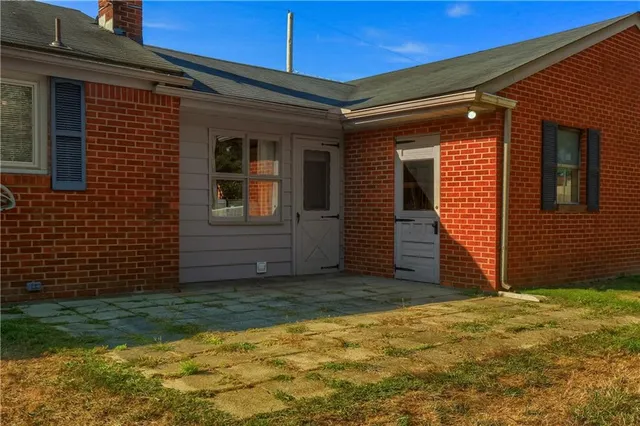 a view of a large garden with plants and large trees