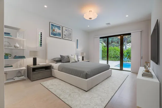 a bedroom with a large bed and a large window