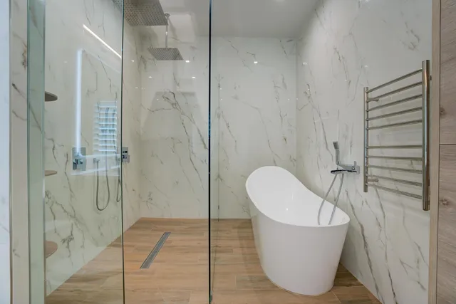 a bathroom with a bathtub and shower