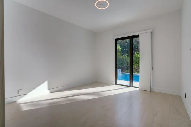 a view of an empty room with glass door