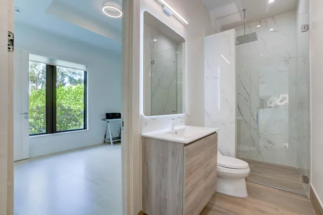 a bathroom with a toilet a sink and shower