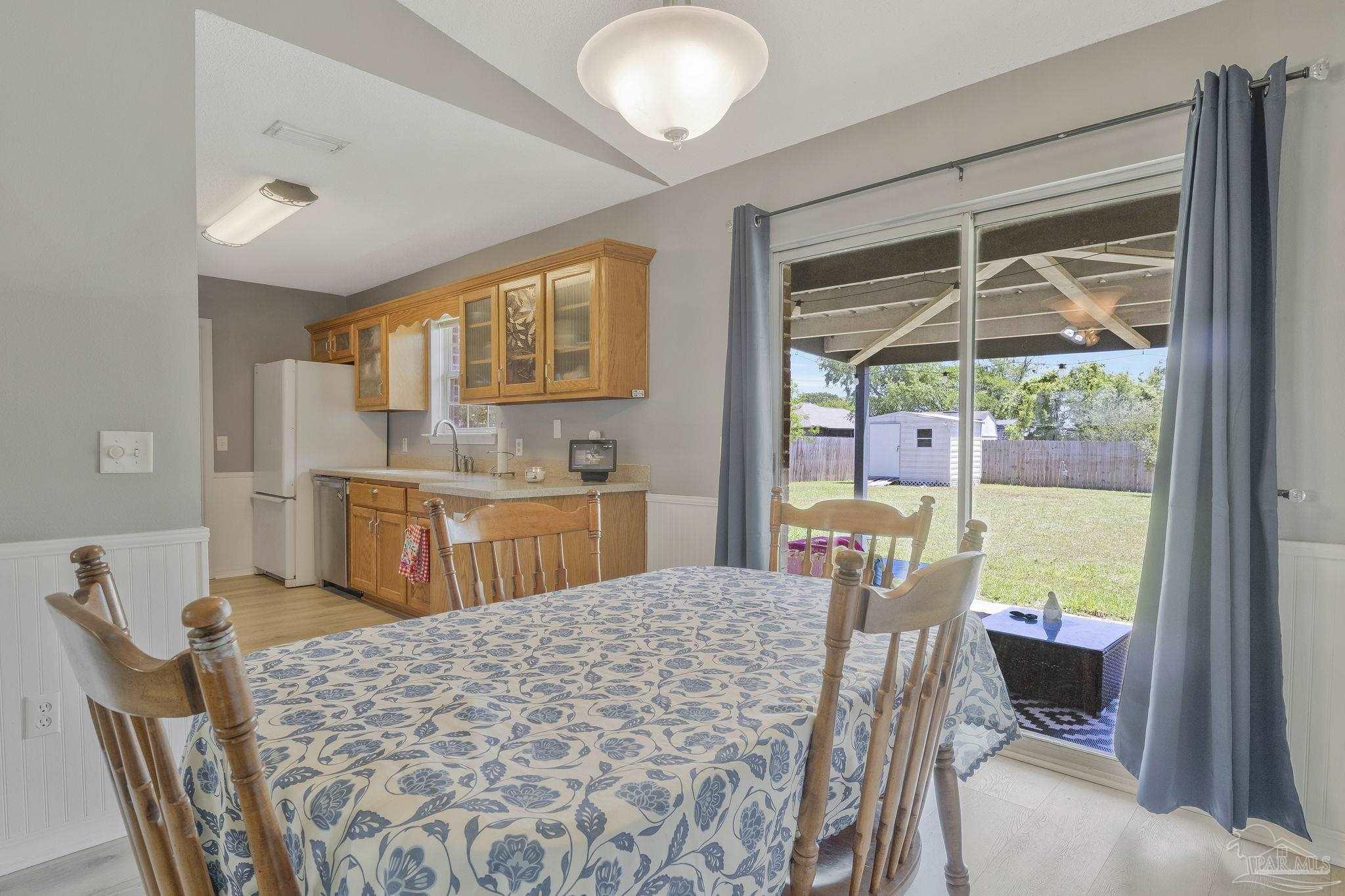 5539 Windrun Place Pace, FL 32571 - Photo 10 of 62 a view of a dining room with furniture window and outside view
