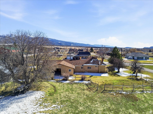 217 East 400 South Spring City, UT 84662 - Photo 54 of 71 Aerial perspective of suburban area featuring a mountainous background