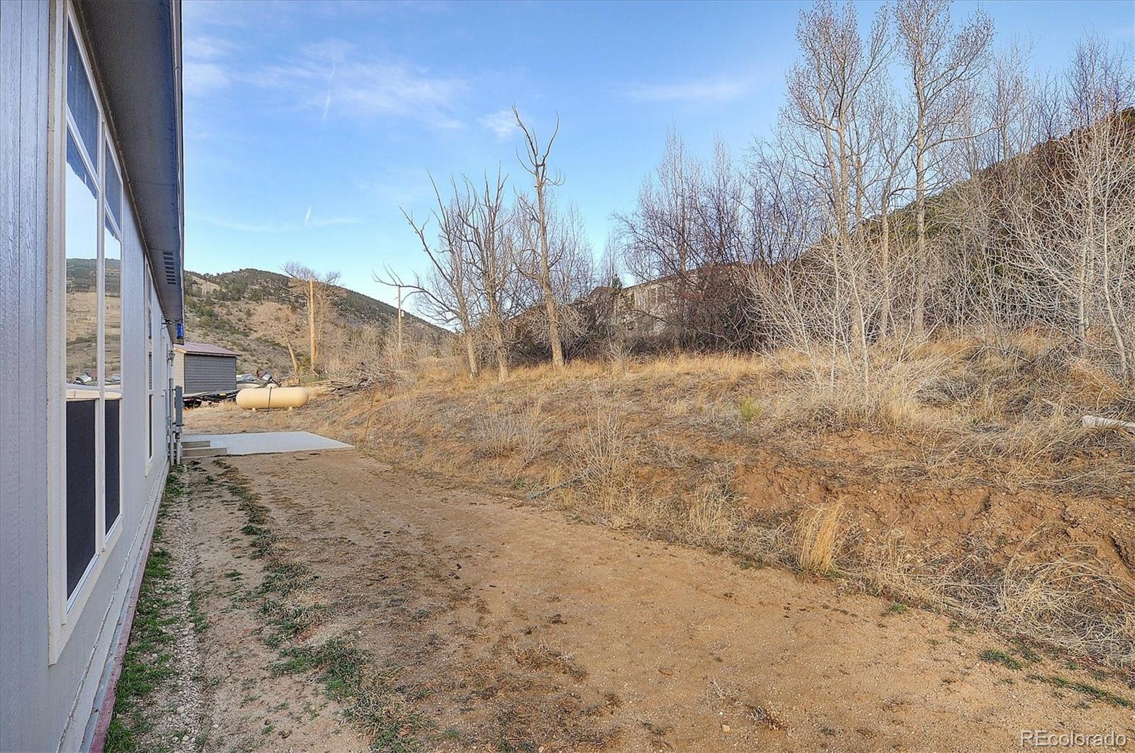 16554 Rocky Mountain Road Salida, CO 81201 - Photo 30 of 33 a view of a yard with trees in front of house