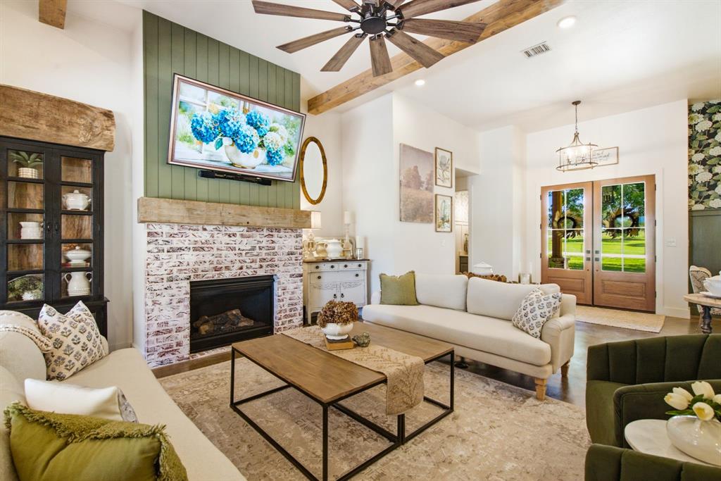 200 Greene Road Wilmer, TX 75172 - Photo 7 of 40 a living room with furniture a flat screen tv and a fireplace