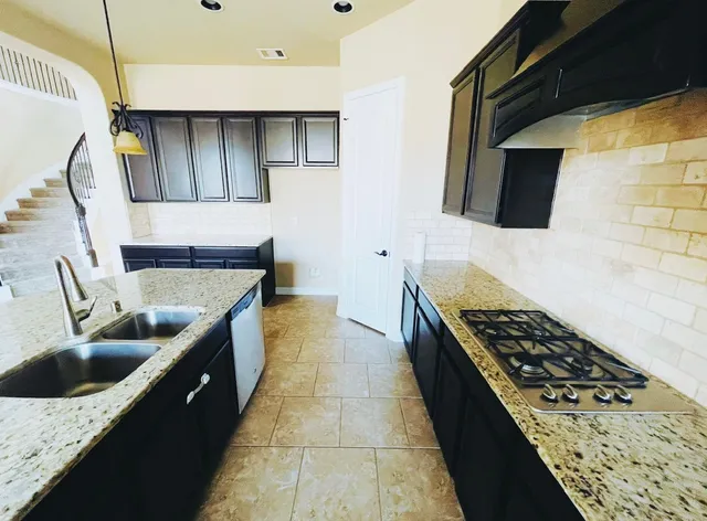 a kitchen with sink cabinets and stove