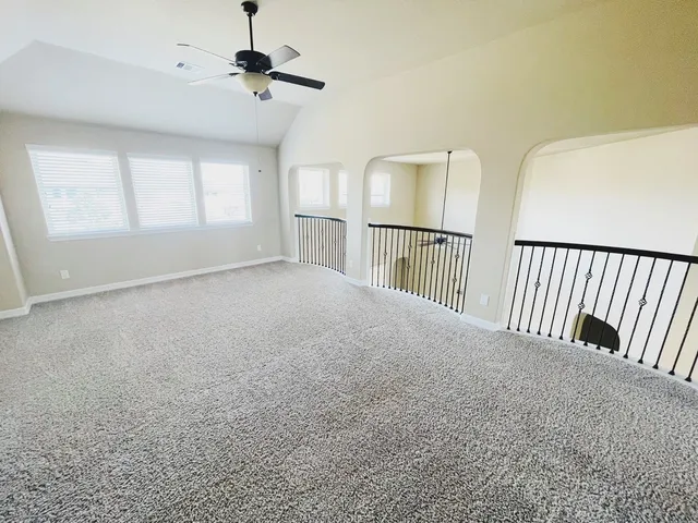 a view of a livingroom with a ceiling fan and window