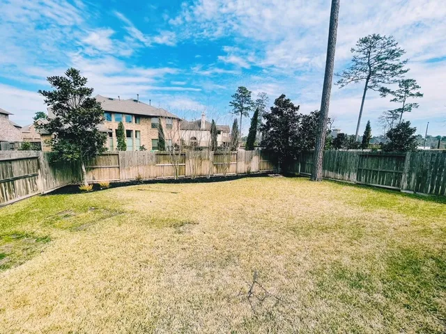 a aerial view of a house with swimming pool and next to a yard