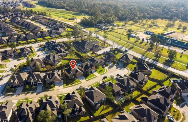an aerial view of residential houses with outdoor space