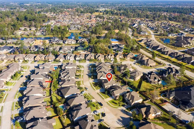an aerial view of a house with a park