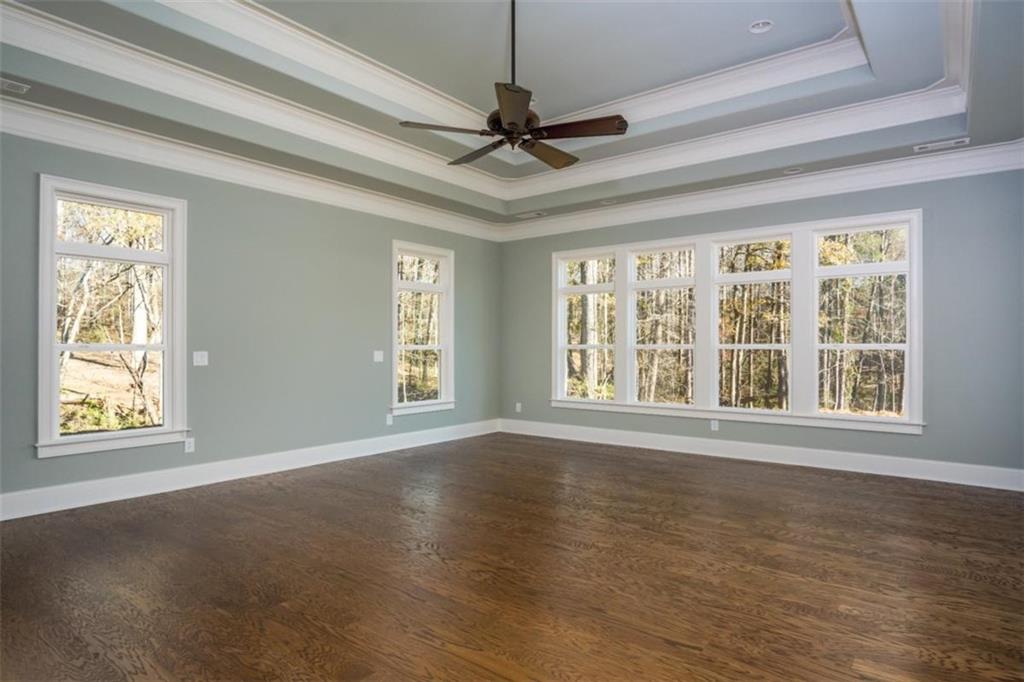 2 Cox Road Woodstock, GA 30188 - Photo 36 of 37 a view of an empty room with a window and wooden floor