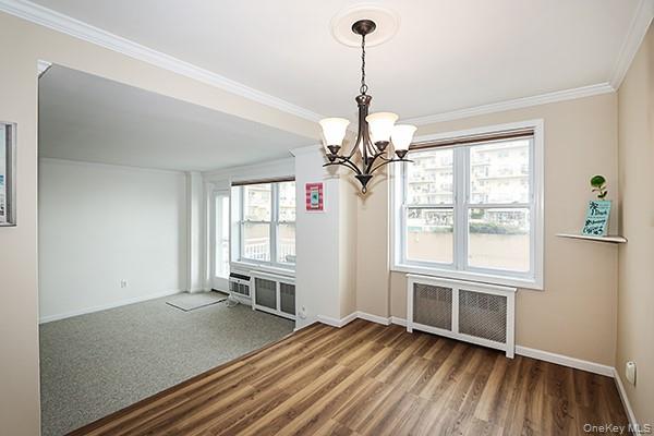 522 Shore Road, Unit 1D Long Beach, NY 11561 - Photo 11 of 22 a view of empty room with wooden floor and fan