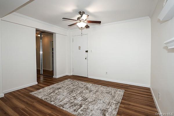 522 Shore Road, Unit 1D Long Beach, NY 11561 - Photo 3 of 22 a view of a room with wooden floor and ceiling fan
